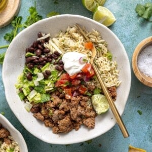 Ground beef burrito bowls served with lime on the side.