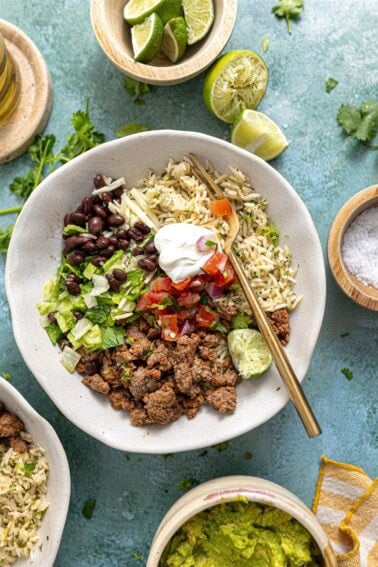 Ground beef burrito bowls served with lime on the side.