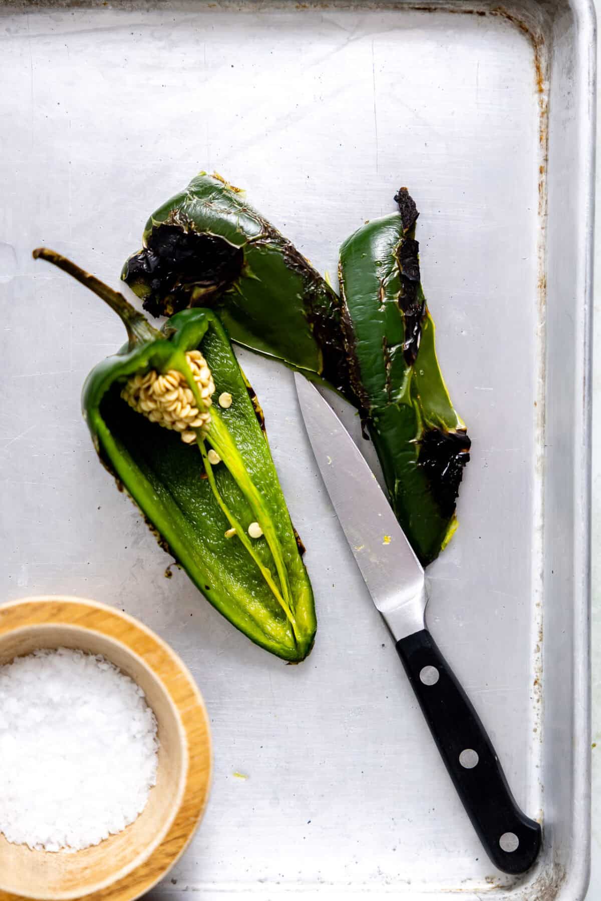 Roasted poblano pepper being de-seeded.