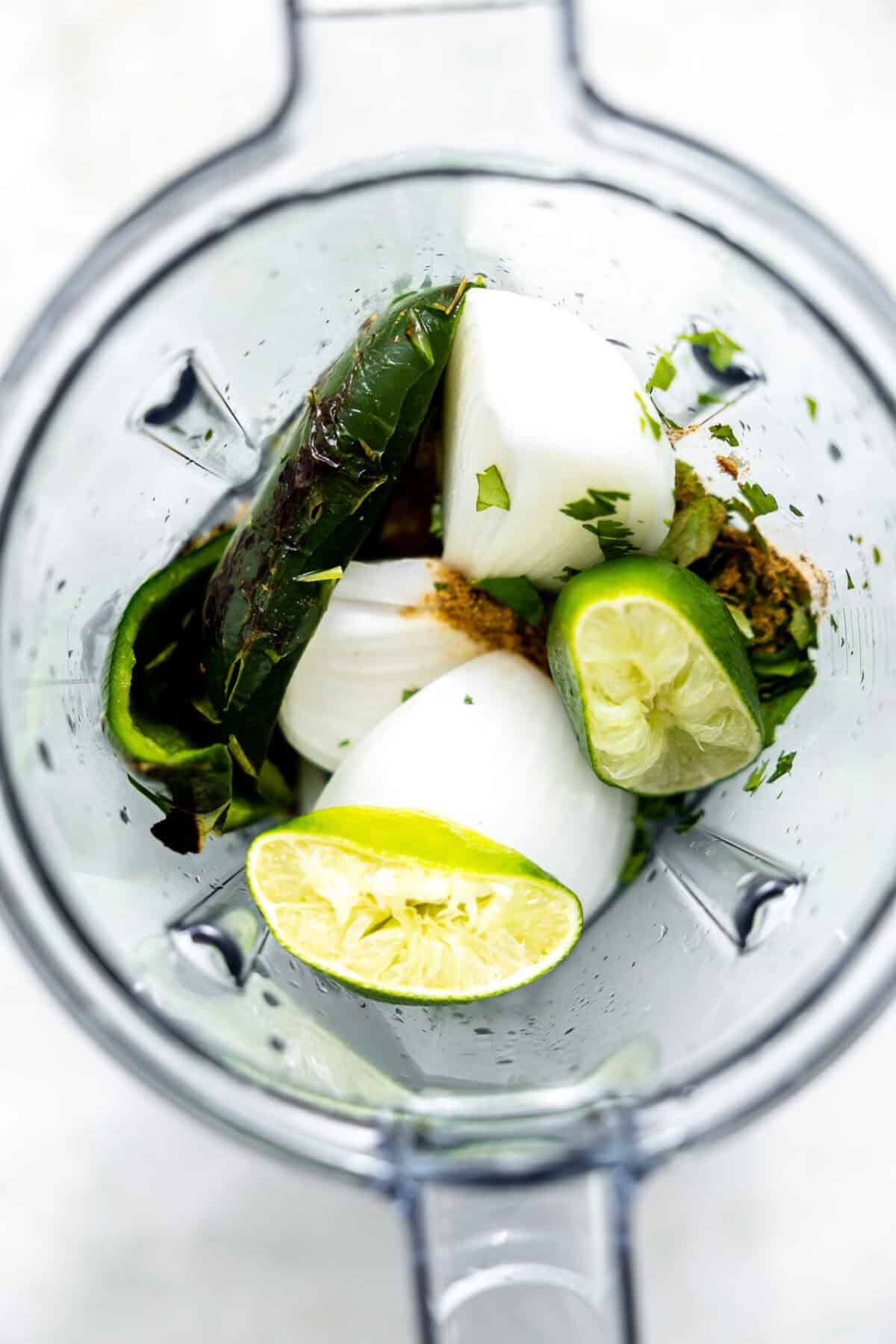 Poblano, cilantro, onion, garlic, lime juice in a blender for making Mexican green rice.