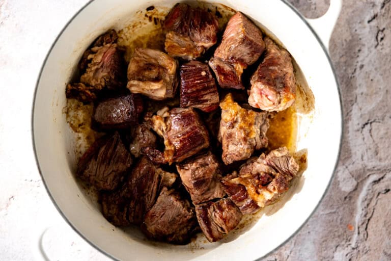 Seared chuck roast in a skillet.