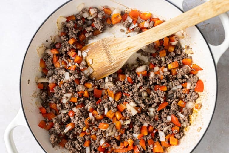 A pan with ground beef, carrots and onions
