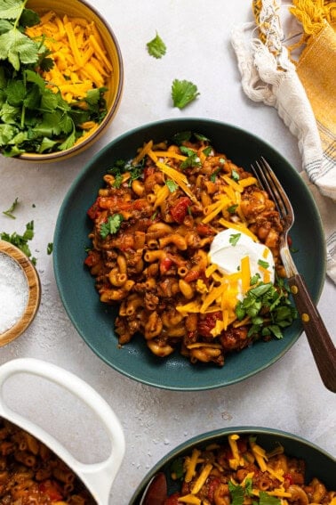 Three bowls of chili Mac on a table
