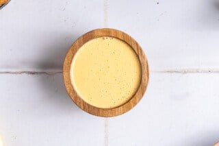 Creamy hollandaise in a wooden bowl.