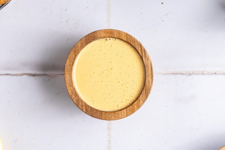 Creamy hollandaise in a wooden bowl.