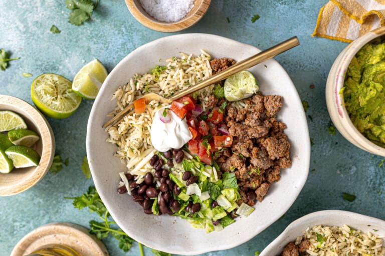 Ground beef burrito bowls served with lime on the side.