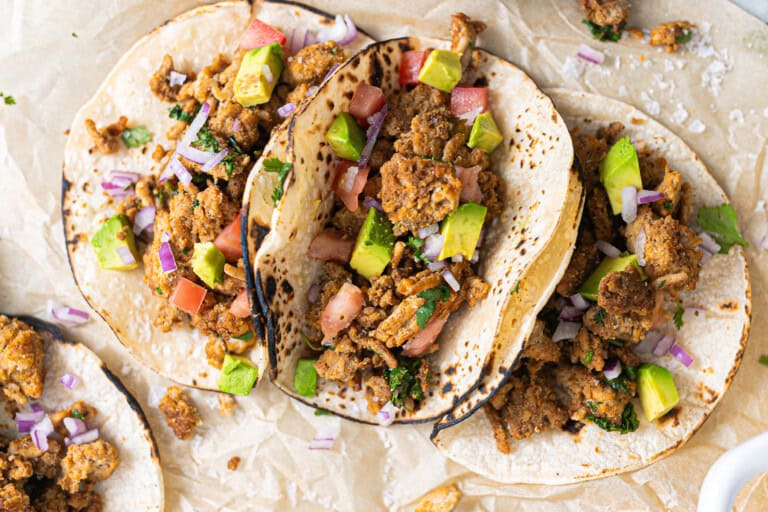 Corn tortillas with cooked ground chicken.