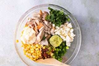 Ingredients for street corn chicken salad in a bowl before mixing.