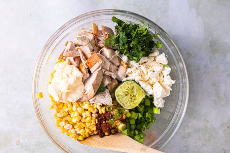 Ingredients for street corn chicken salad in a bowl before mixing.