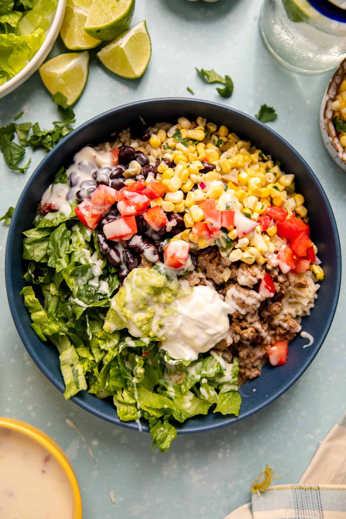 Ground beef burrito bowls served with lime on the side.