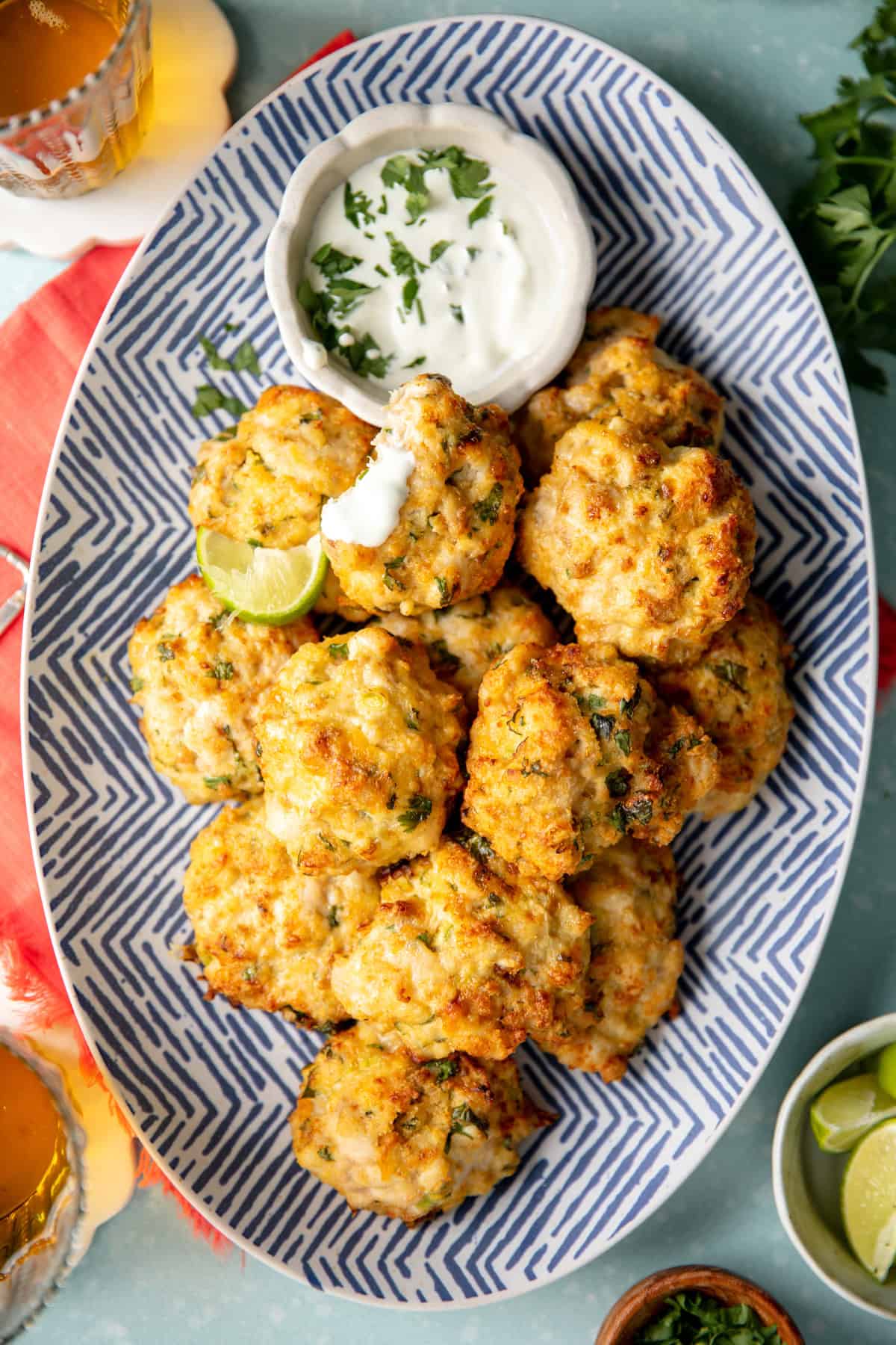 Plate of chicken fritters with cilantro lime crema dipping sauce.