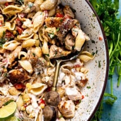Chicken taco pasta salad served in a bowl with a wooden handled spoon.