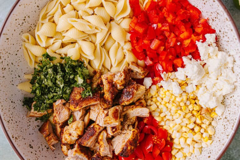 Ingredients needed to make a taco pasta salad in a bowl before dressing.