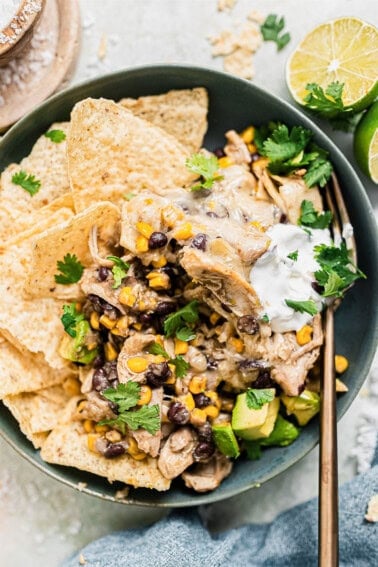 Green Chicken Enchilada casserole served over tortilla chips with rice.