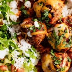 Up close of cooked enchilada meatballs served over rice.