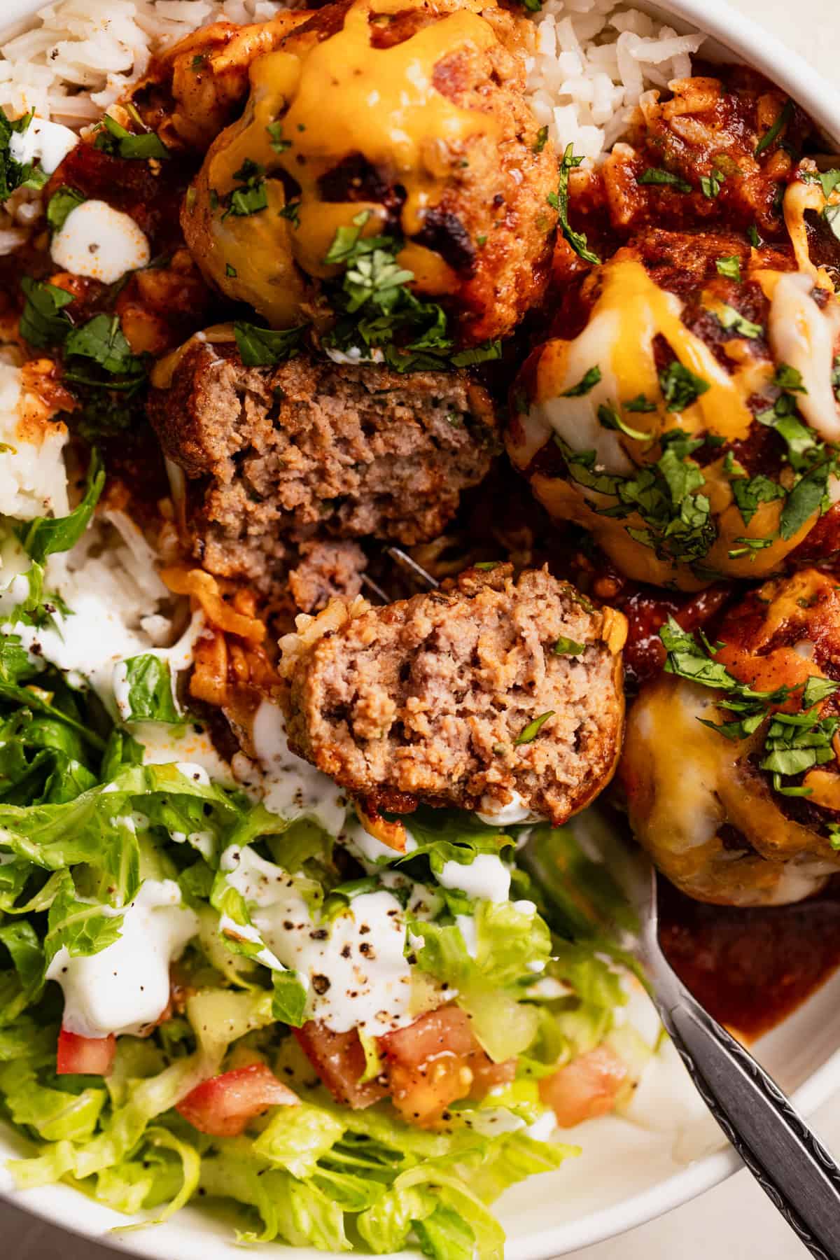 Up close of cut open enchilada meatball showing tender texture inside. 