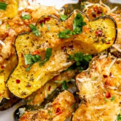 Garlic Parmesan Roasted Acorn Squash served on a plate and garnished with parsley.