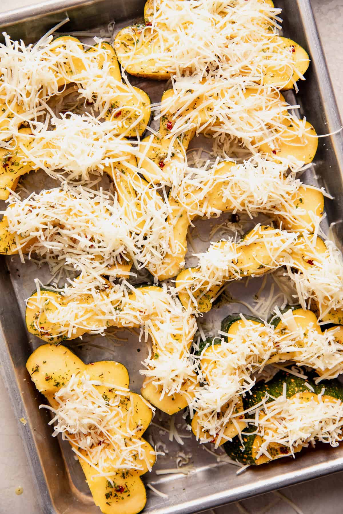 Acorn squash topped with grated parmesan cheese before baking. 