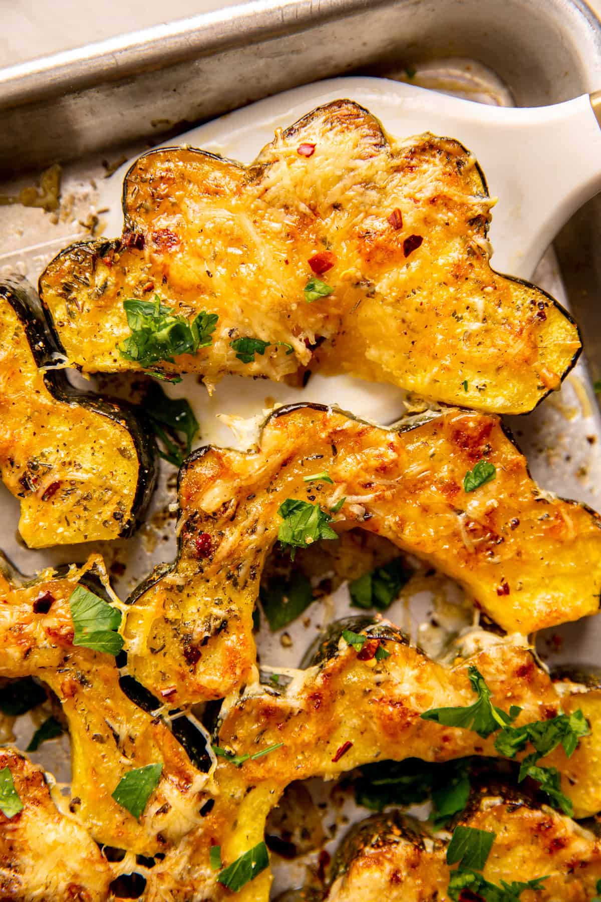 Roasted Acorn Squash being served with a spatula. 