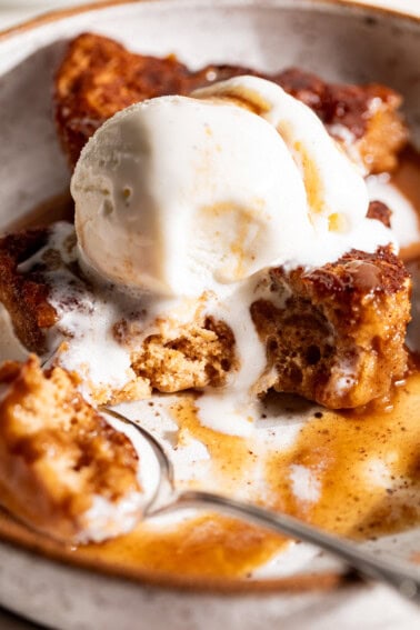 Slice of snickerdoodle cobbler topped with melty vanilla ice cream.