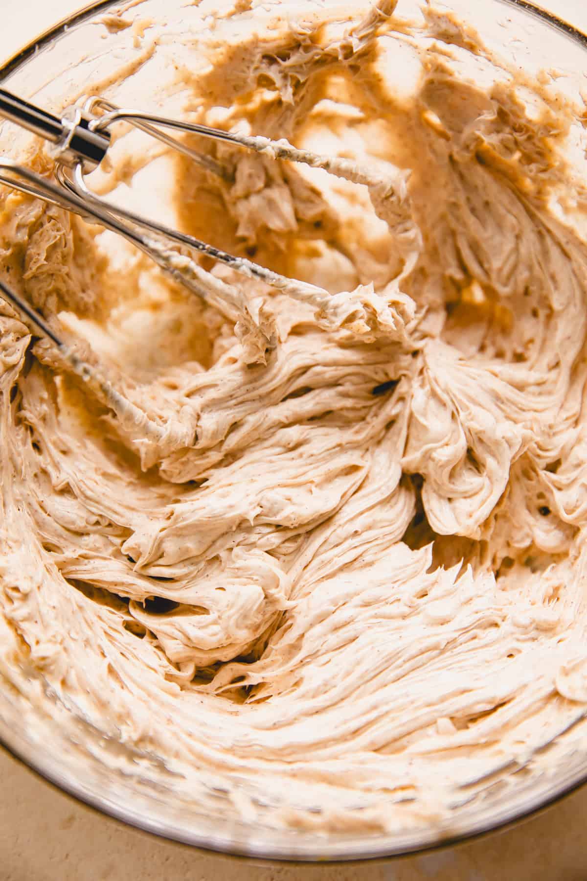 Whipped Cinnamon honey butter in a bowl with beaters.