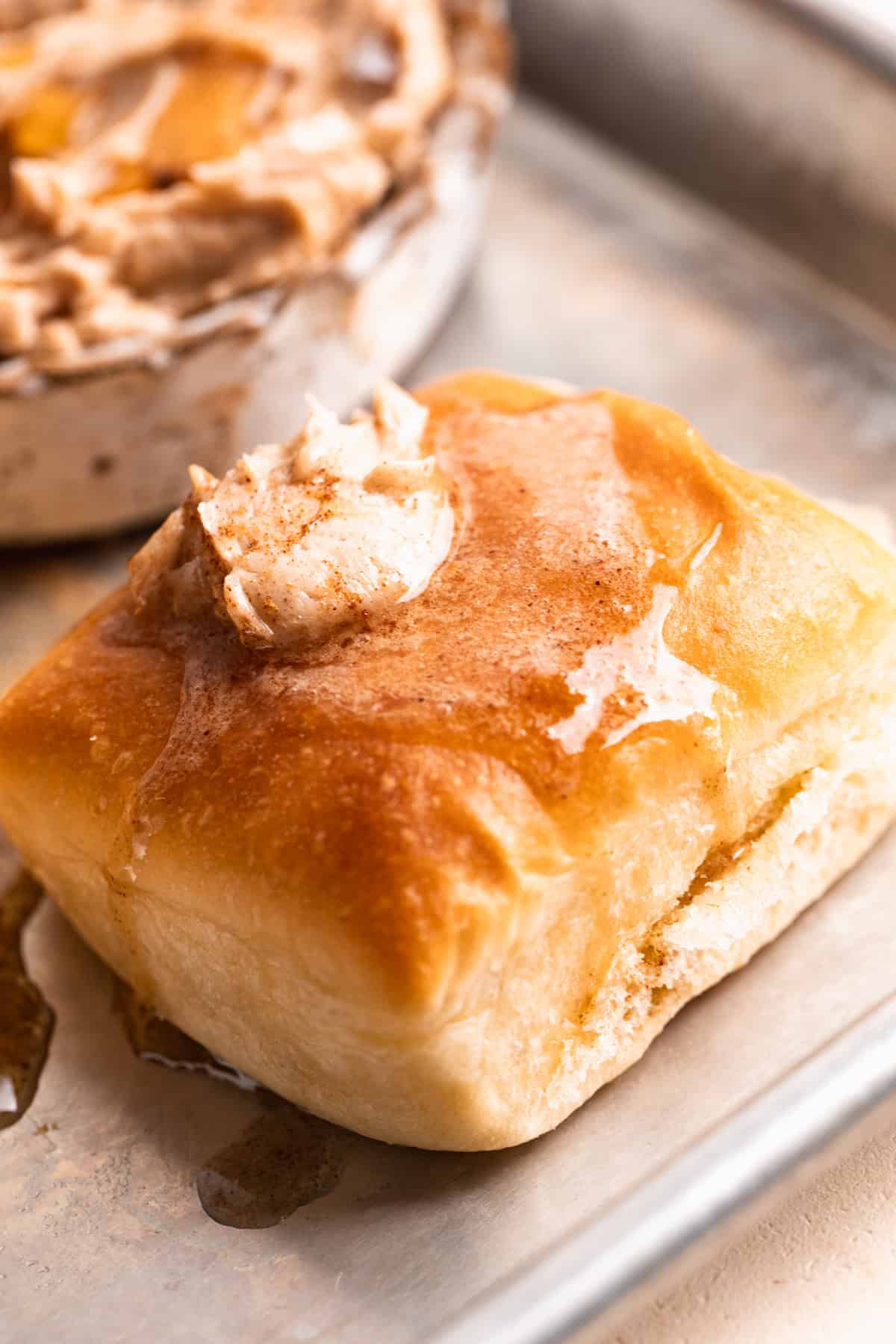 Texas Roadhouse rolls topped with melting cinnamon honey butter. 