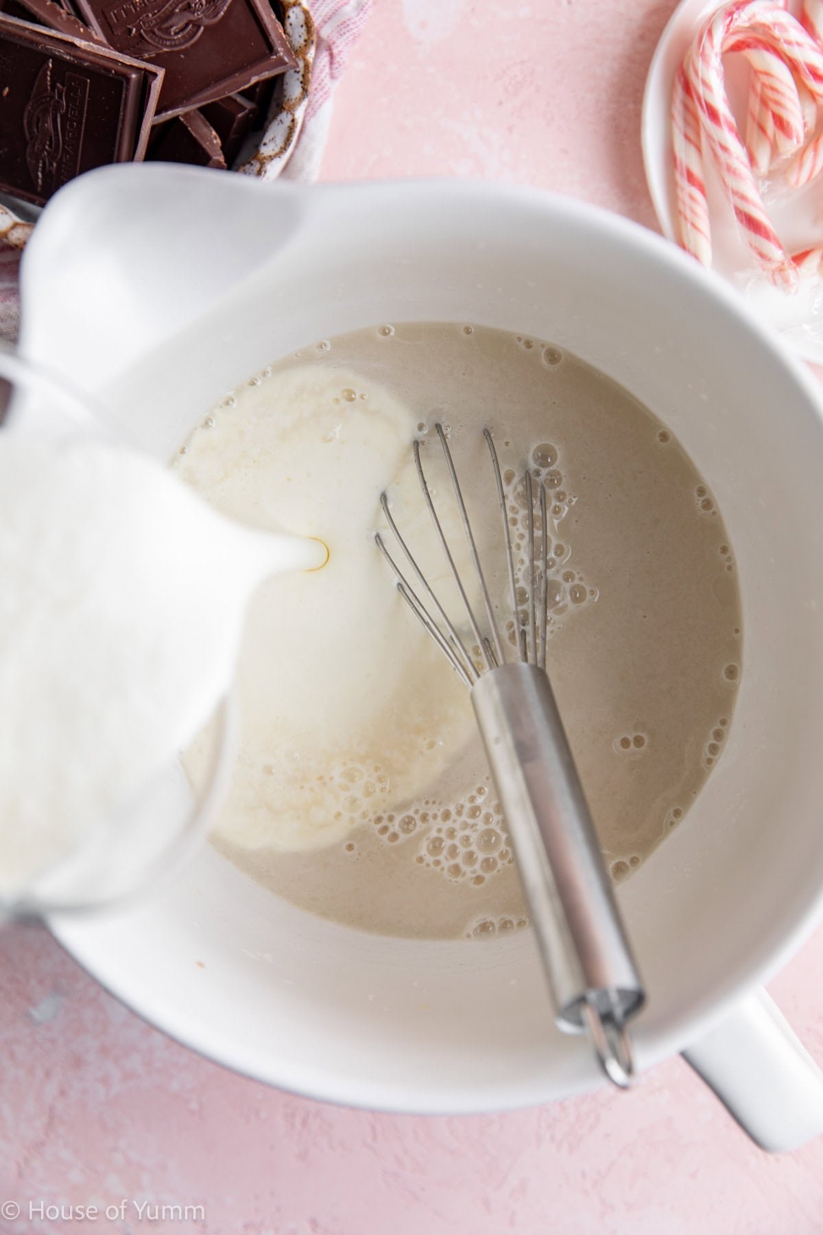 Whisking cream into milk, sugar mixture for making homemade ice cream.