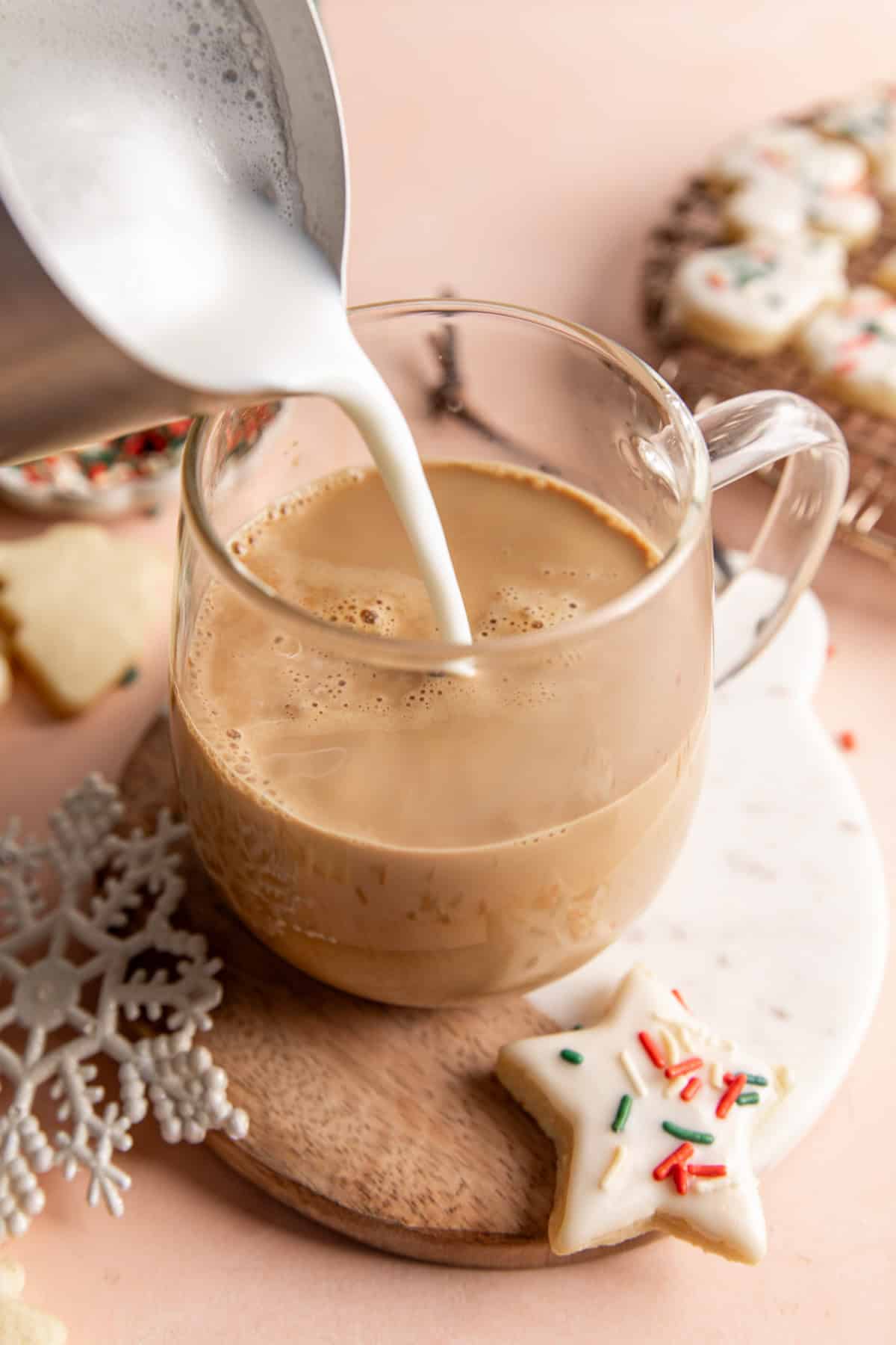 Pouring frothed milk into a latte.