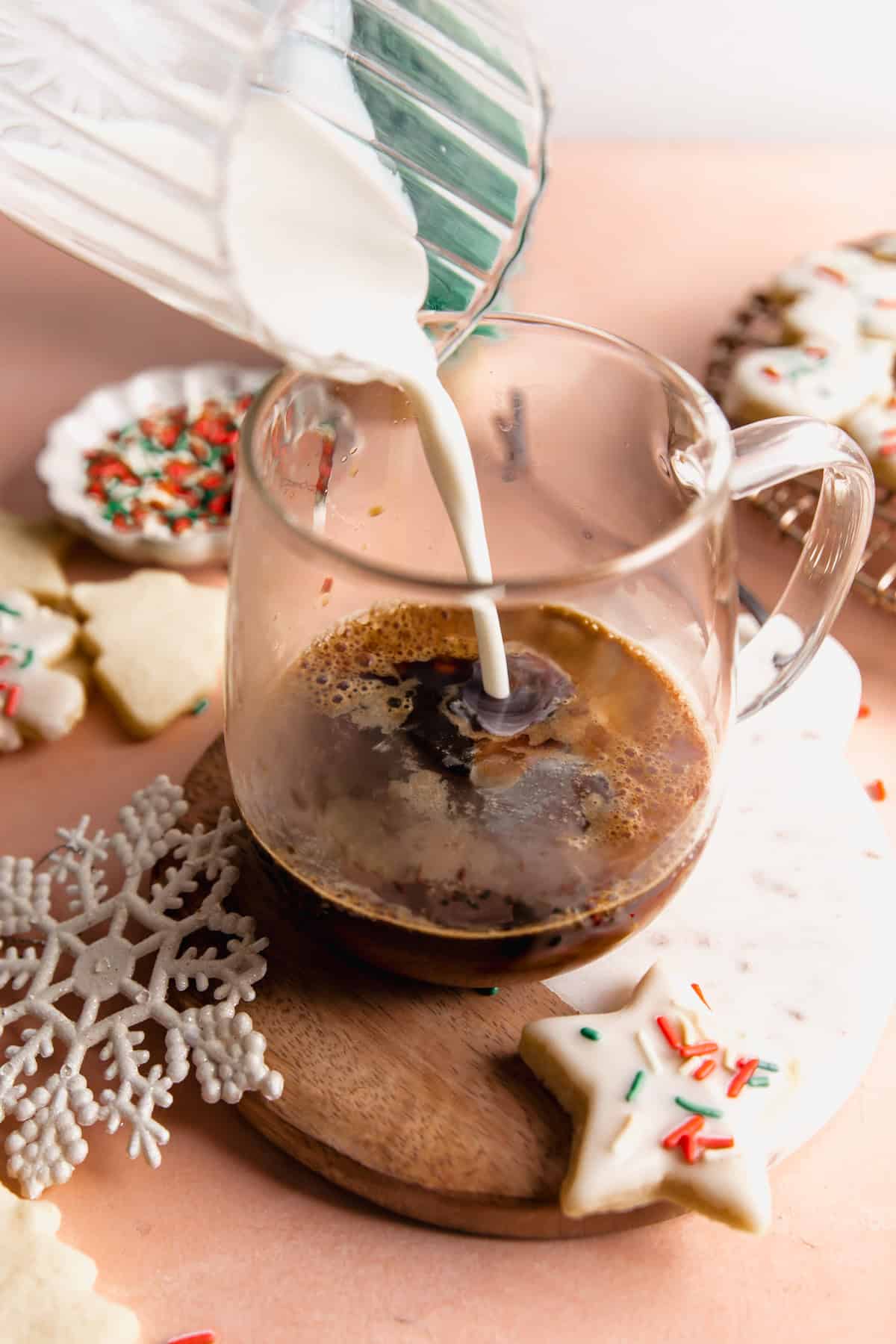 Adding creamer to a mug of espresso.