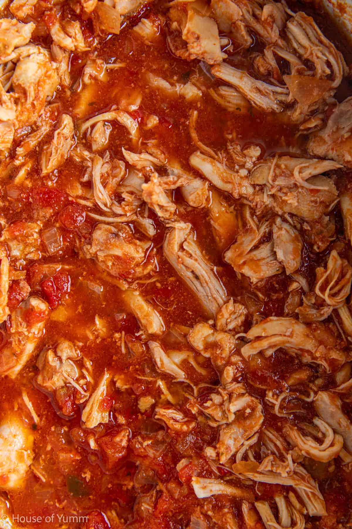 Shredded salsa chicken in a slow cooker.