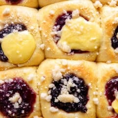 Up close view of berry and cream kolaches in a baking pan.
